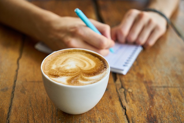 Cup of coffee and person noting in background